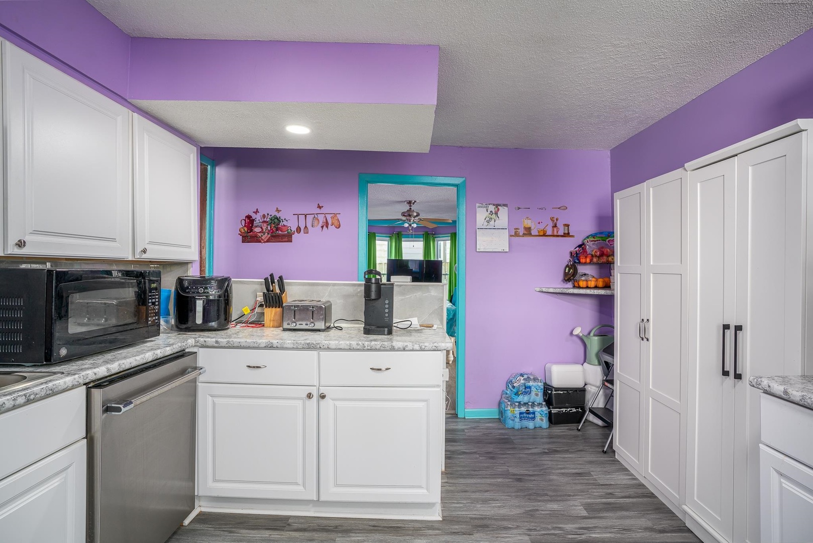 1708 Pershing Boulevard Clinton, IA 52732 - Photo 6 of 18 a kitchen with granite countertop a sink cabinets and stainless steel appliances