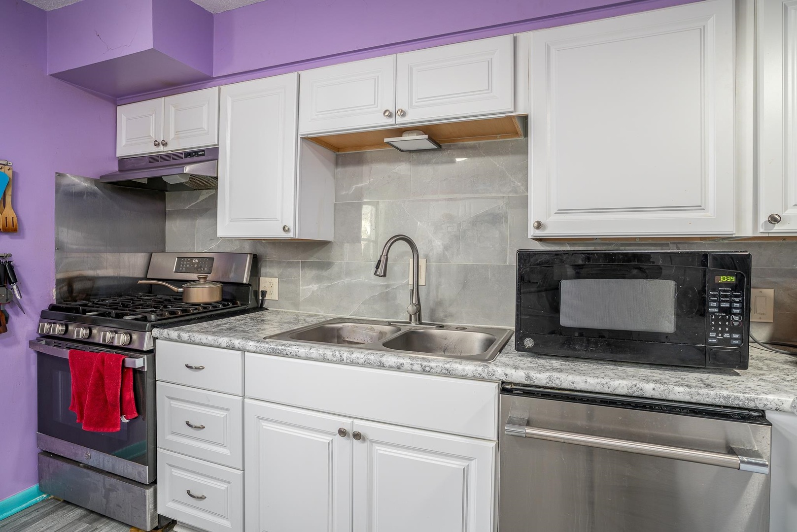 1708 Pershing Boulevard Clinton, IA 52732 - Photo 7 of 18 a kitchen with granite countertop a stove and a sink