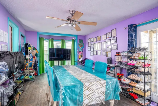 a bed room with a bed tv and a window