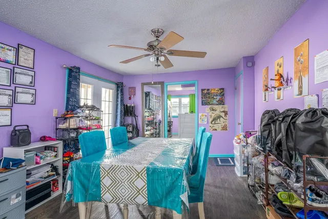 a living room with furniture a chandelier and a dining table