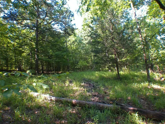 a backyard of a house with a yard and outdoor seating