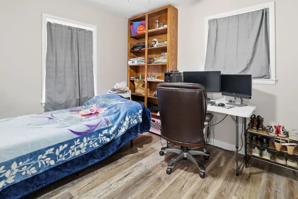 a bedroom with a bed and a desk in it