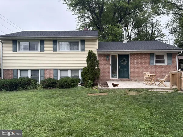 a front view of a house with yard and green space