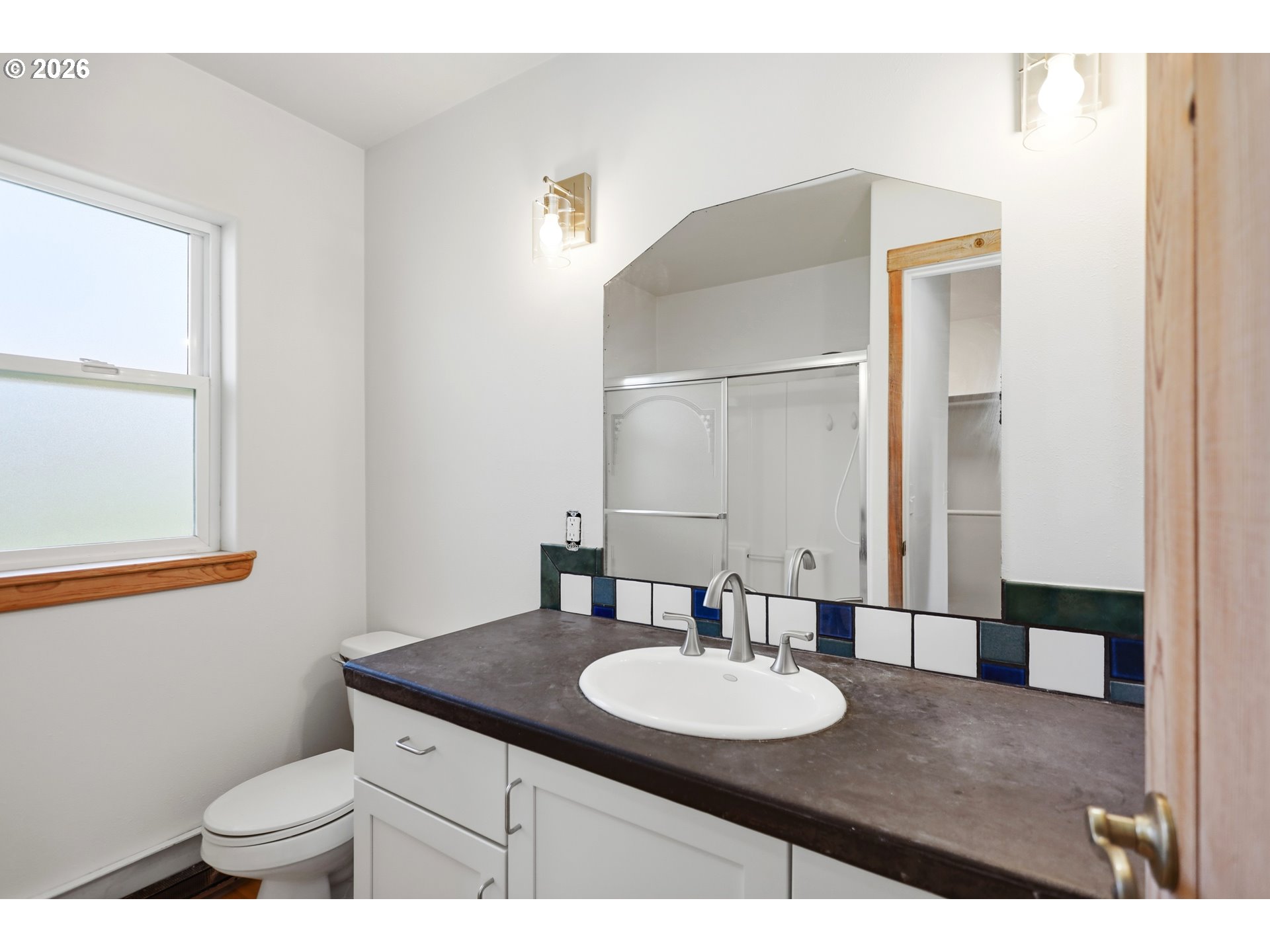 1707 Bridge Street The Dalles, OR 97058 - Photo 19 of 41 a bathroom with a granite countertop sink a toilet and a mirror