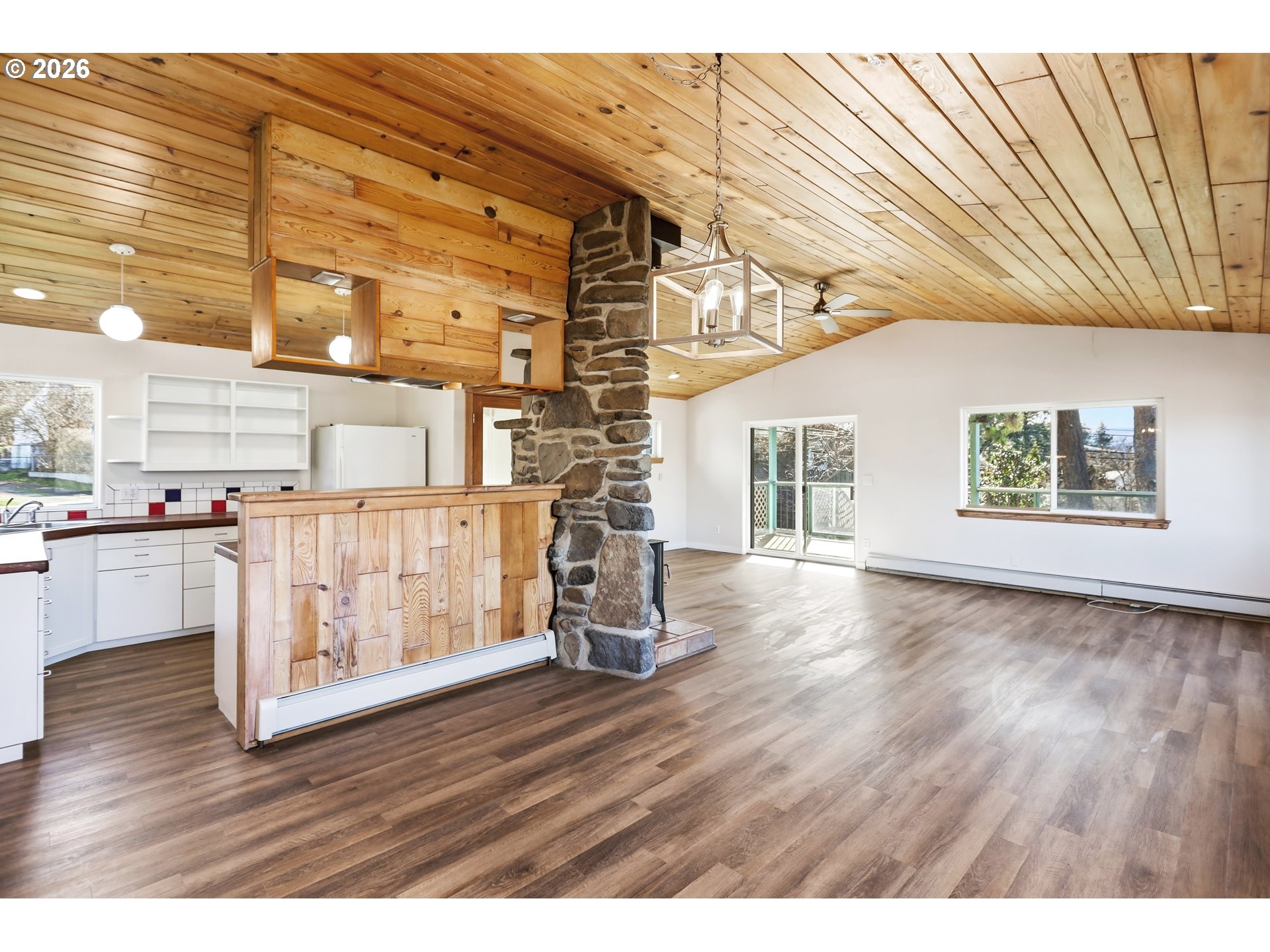 1707 Bridge Street The Dalles, OR 97058 - Photo 3 of 41 a view of an empty room with wooden floor and windows
