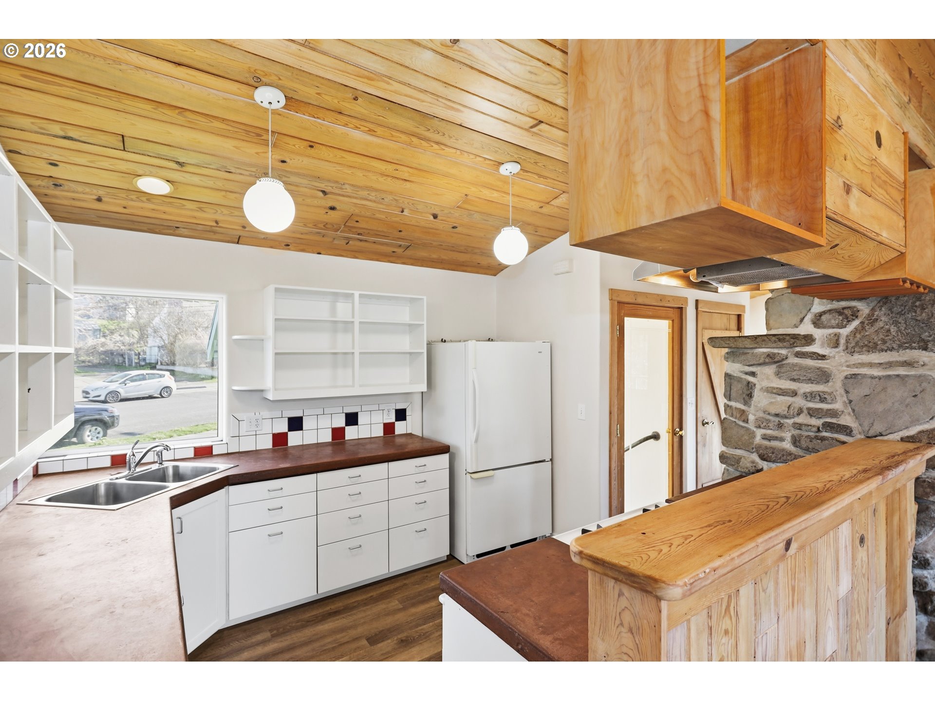1707 Bridge Street The Dalles, OR 97058 - Photo 10 of 41 a kitchen with stainless steel appliances kitchen island granite countertop a sink and cabinets
