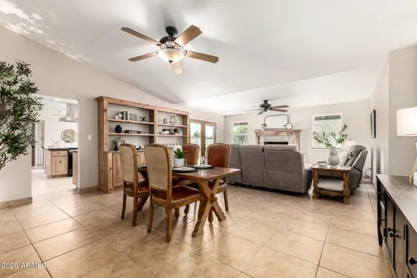 a living room with furniture a chandelier and a rug