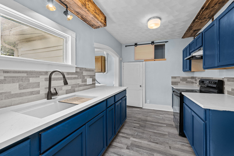 1419 17th Street Moline, IL 61265 - Photo 19 of 28 a kitchen with a sink and a stove top oven