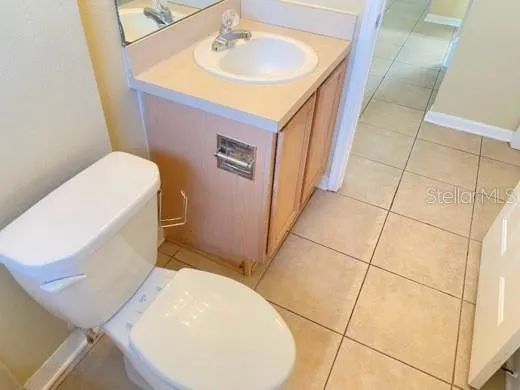 a bathroom with a sink toilet and mirror