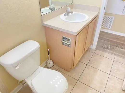 a bathroom with a sink a toilet and mirror