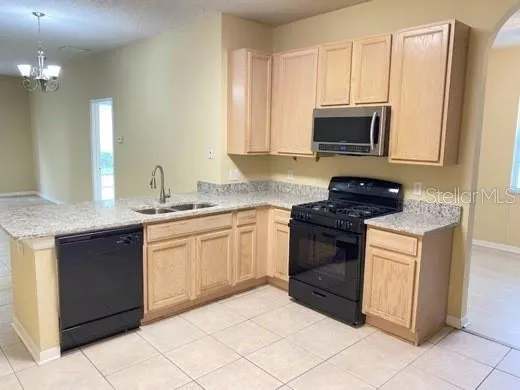 a kitchen with stainless steel appliances granite countertop a sink and a stove
