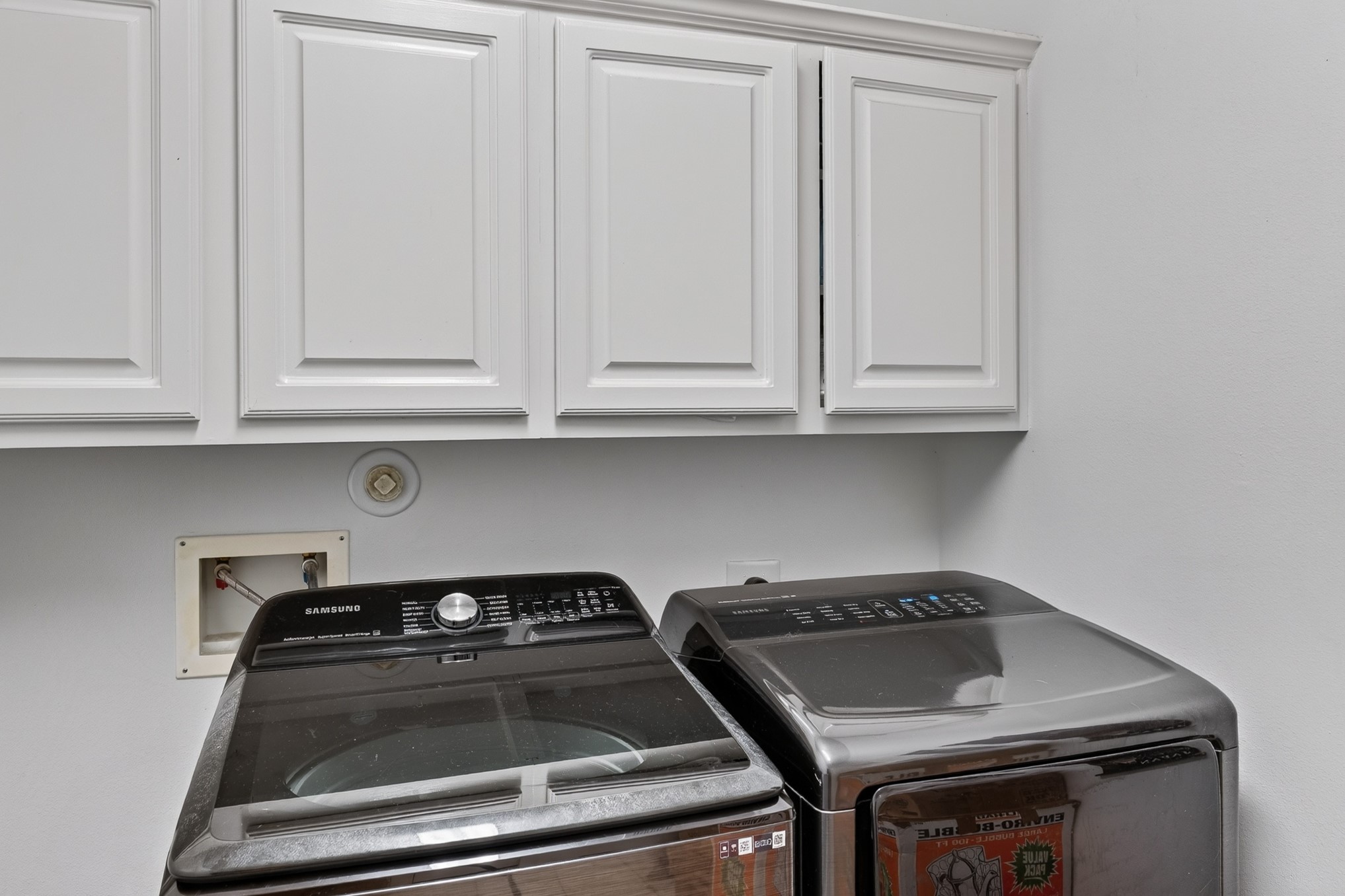 335 Voss Road Houston, TX 77024 - Photo 33 of 50 Functional laundry room with extensive cabinetry and storage.