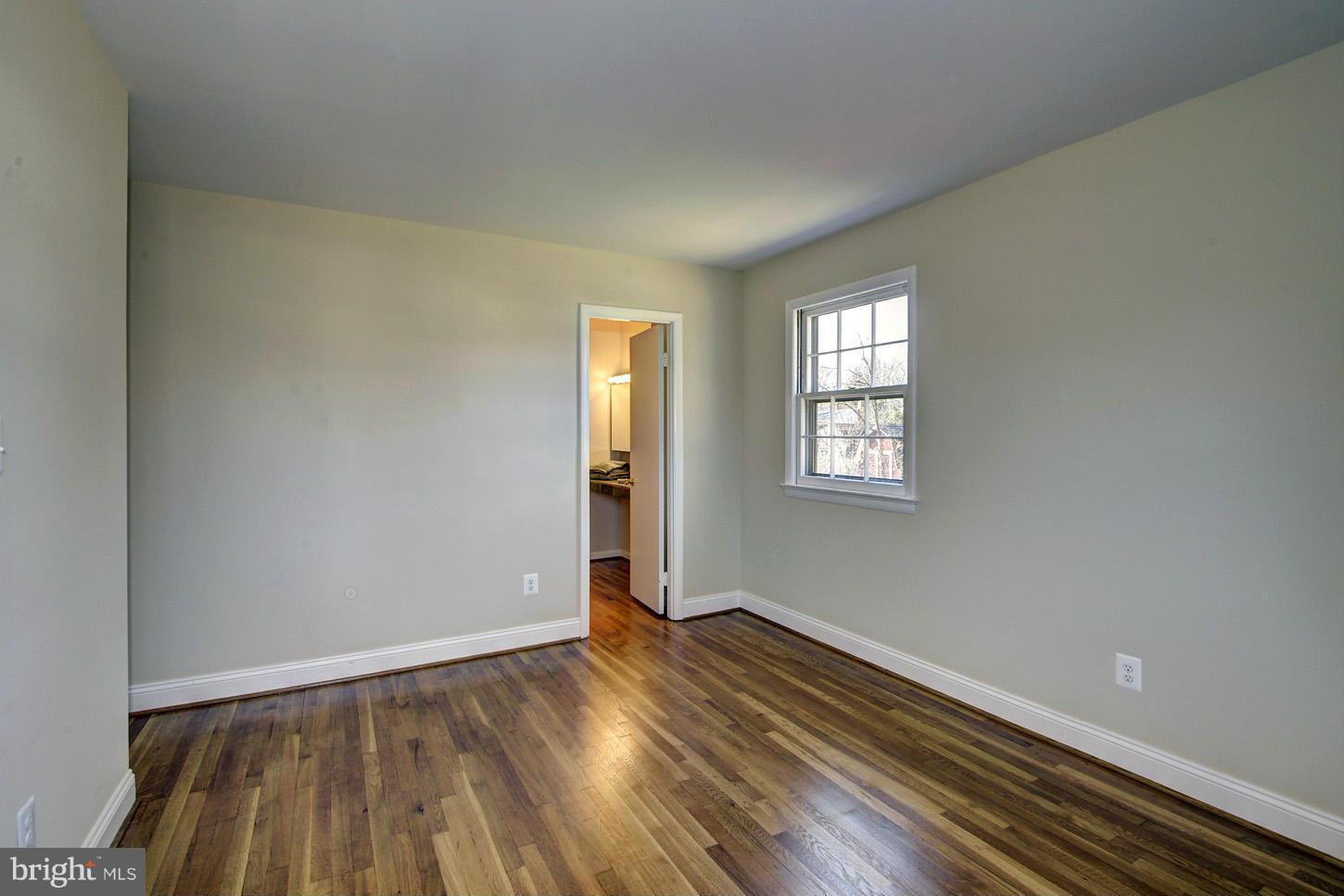 2701 Woodedge Road Silver Spring, MD 20906 - Photo 11 of 27 an empty room with wooden floor and windows