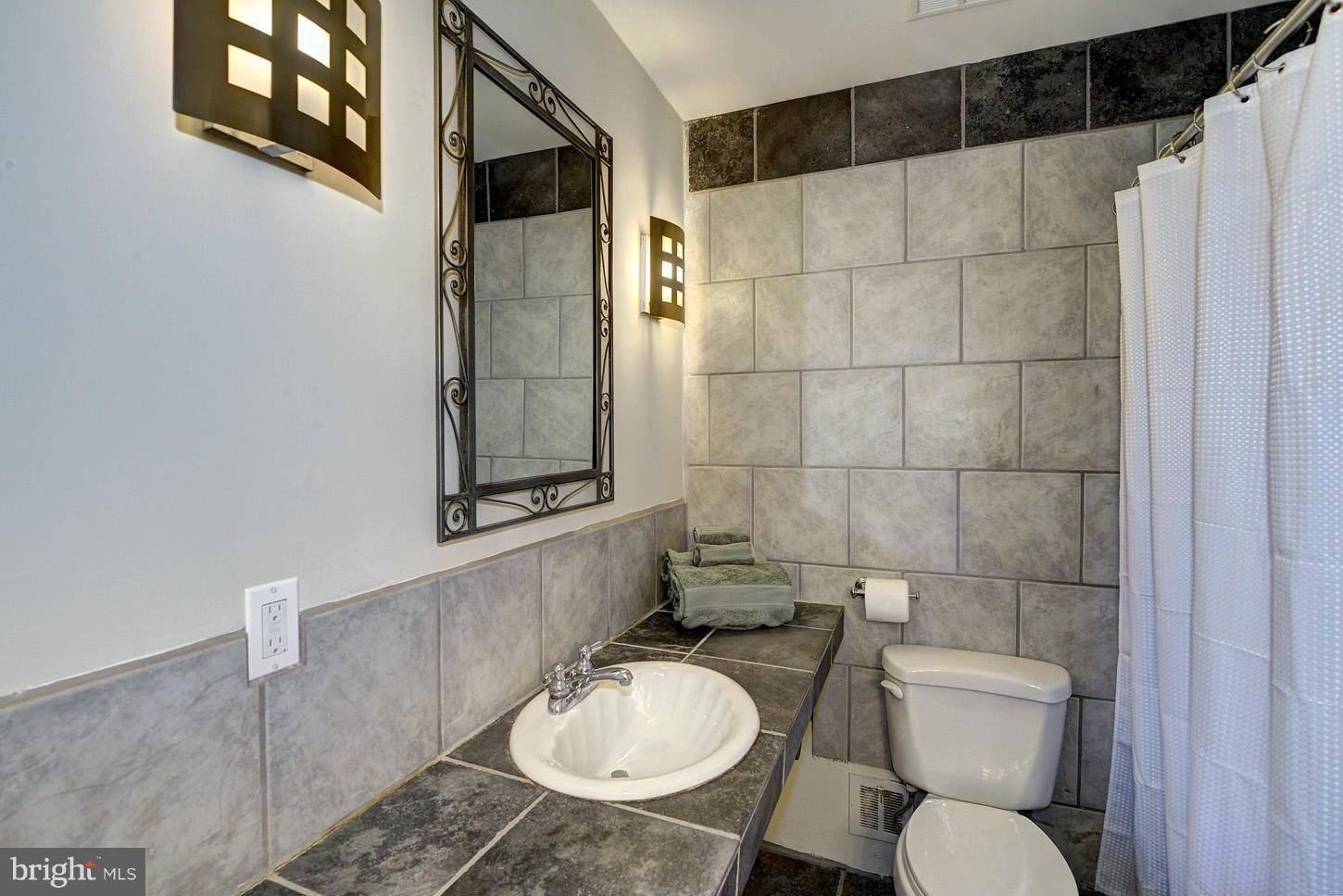 2701 Woodedge Road Silver Spring, MD 20906 - Photo 12 of 27 a bathroom with a toilet a sink and shower