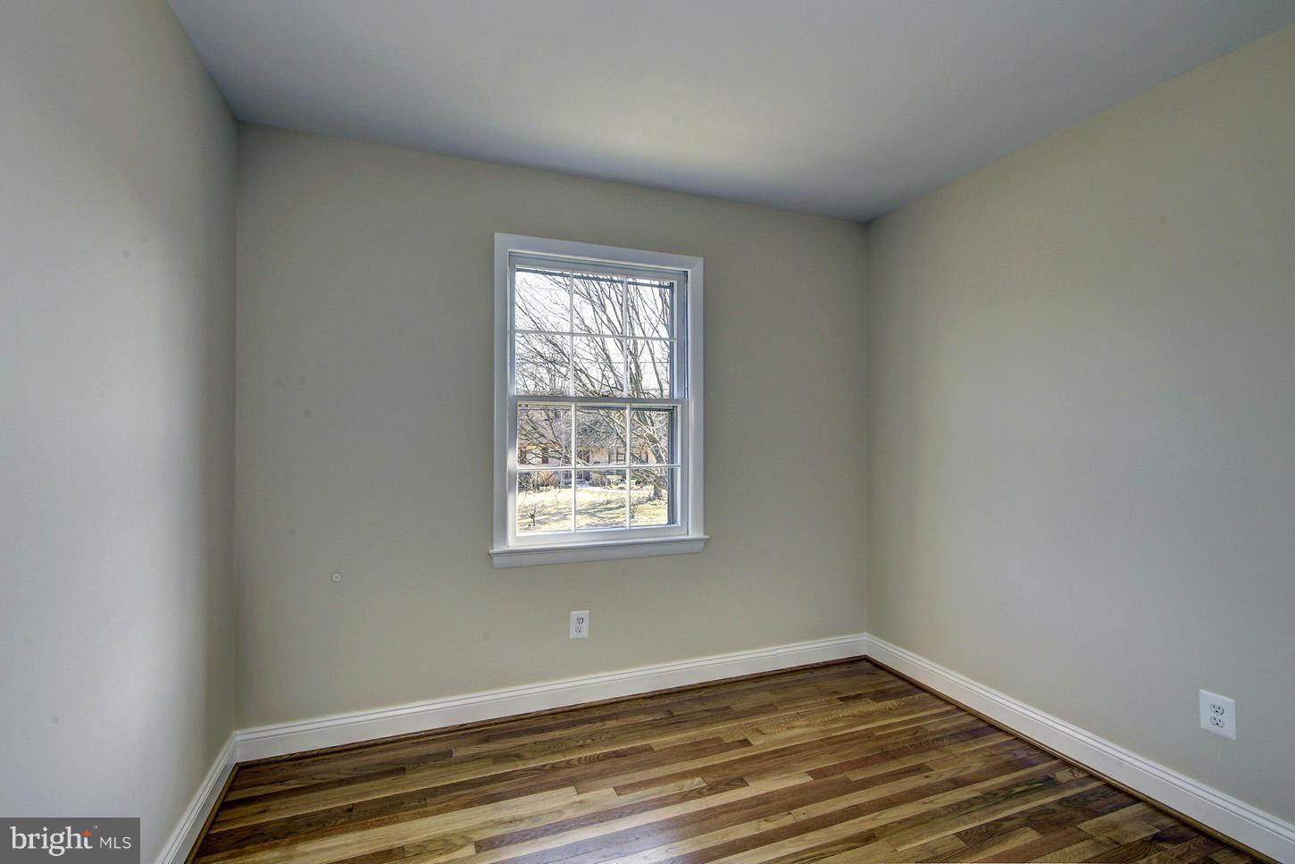 2701 Woodedge Road Silver Spring, MD 20906 - Photo 14 of 27 a view of an empty room with wooden floor and a window