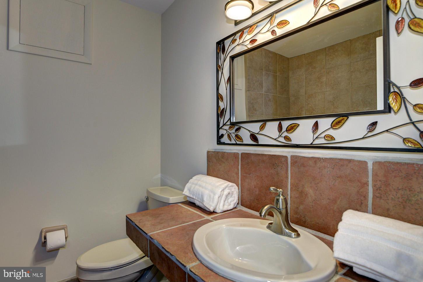 2701 Woodedge Road Silver Spring, MD 20906 - Photo 17 of 27 a bathroom with a toilet sink and mirror