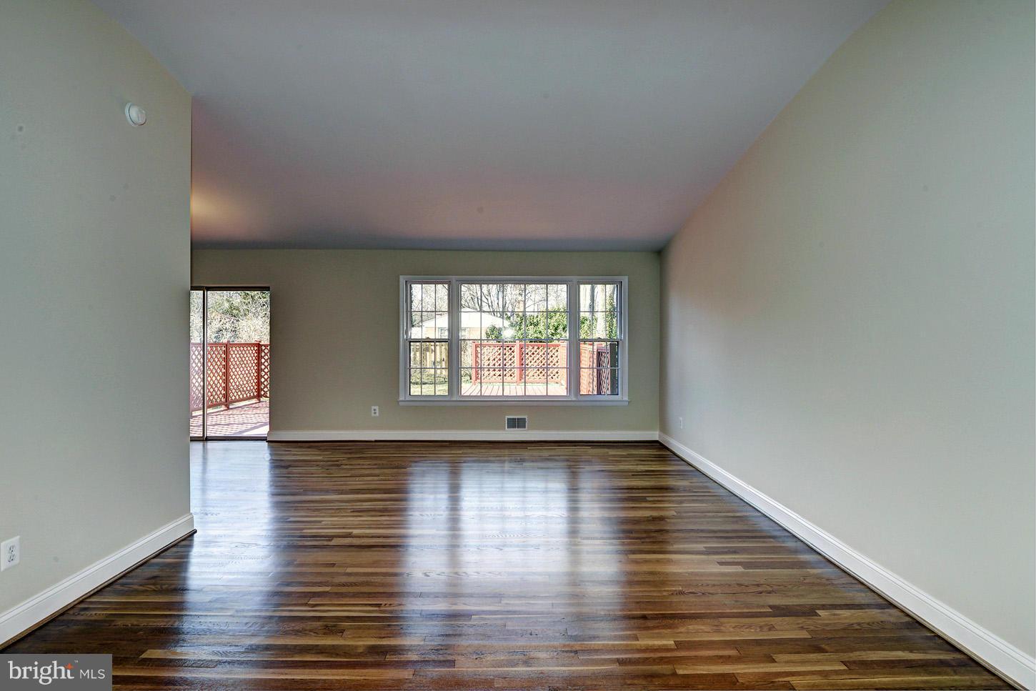 2701 Woodedge Road Silver Spring, MD 20906 - Photo 3 of 27 a view of an empty room with wooden floor and a window