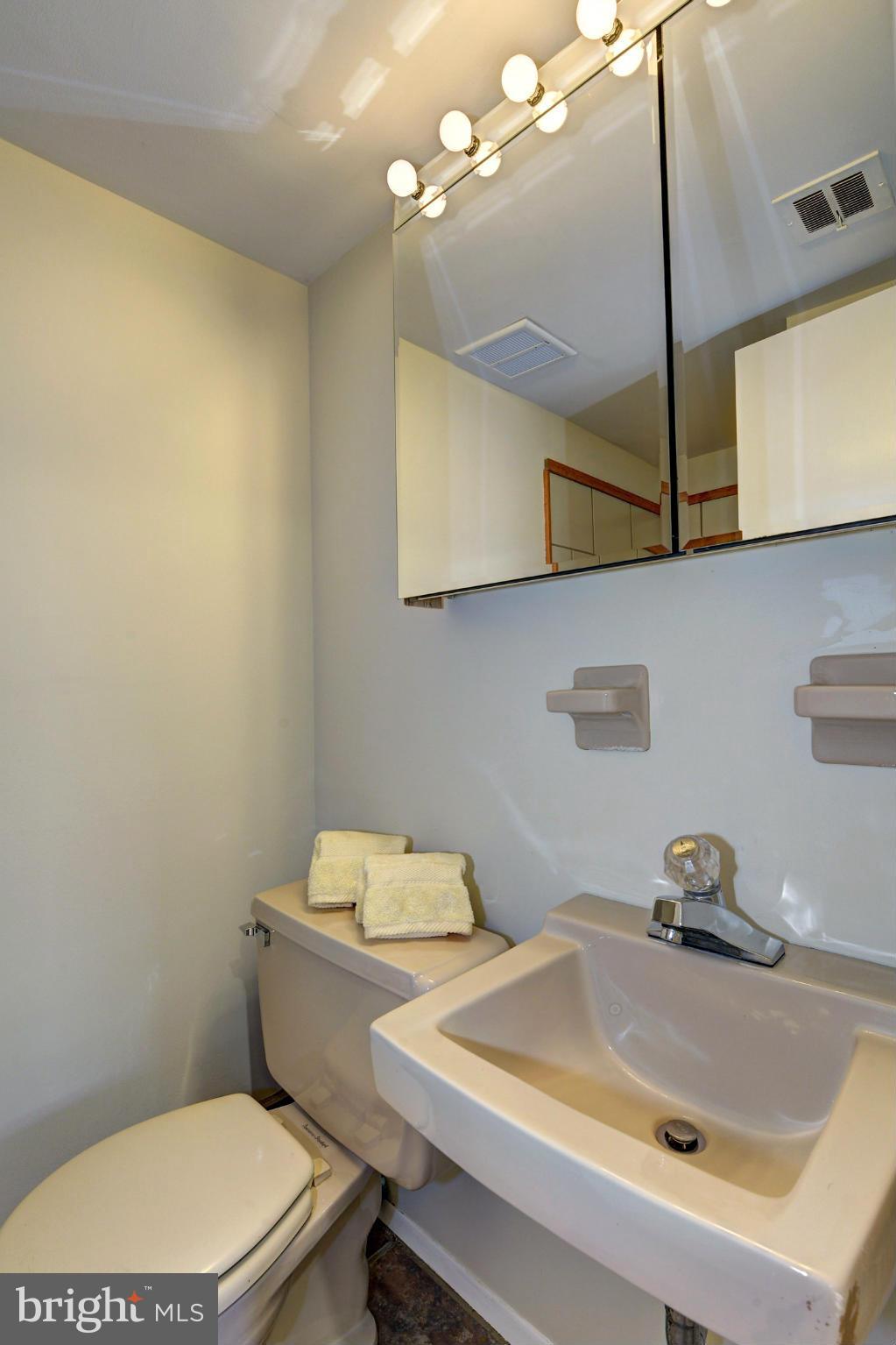 2701 Woodedge Road Silver Spring, MD 20906 - Photo 21 of 27 a bathroom with a sink a toilet and mirror