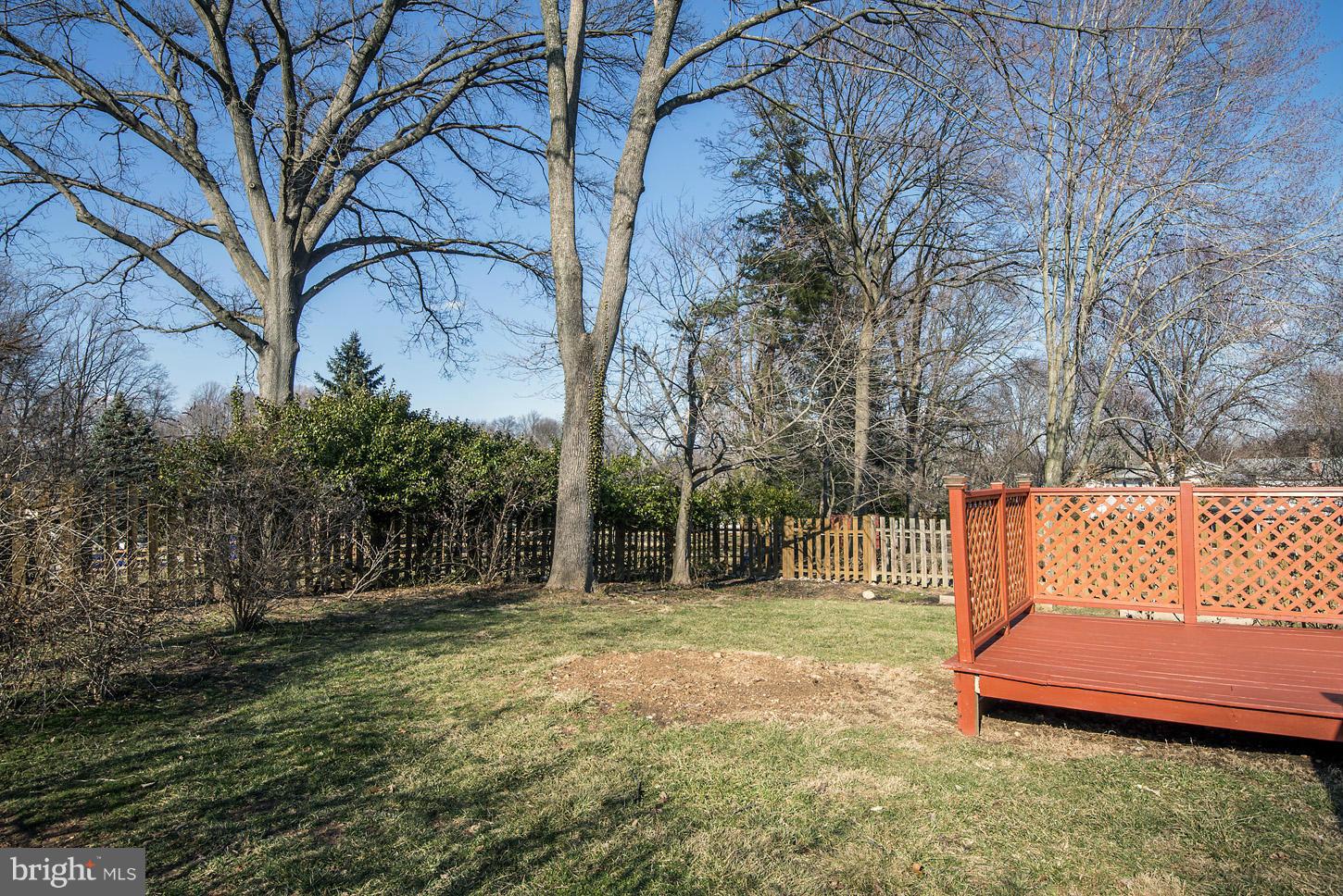 2701 Woodedge Road Silver Spring, MD 20906 - Photo 25 of 27 a backyard of a house with large trees and wooden fence