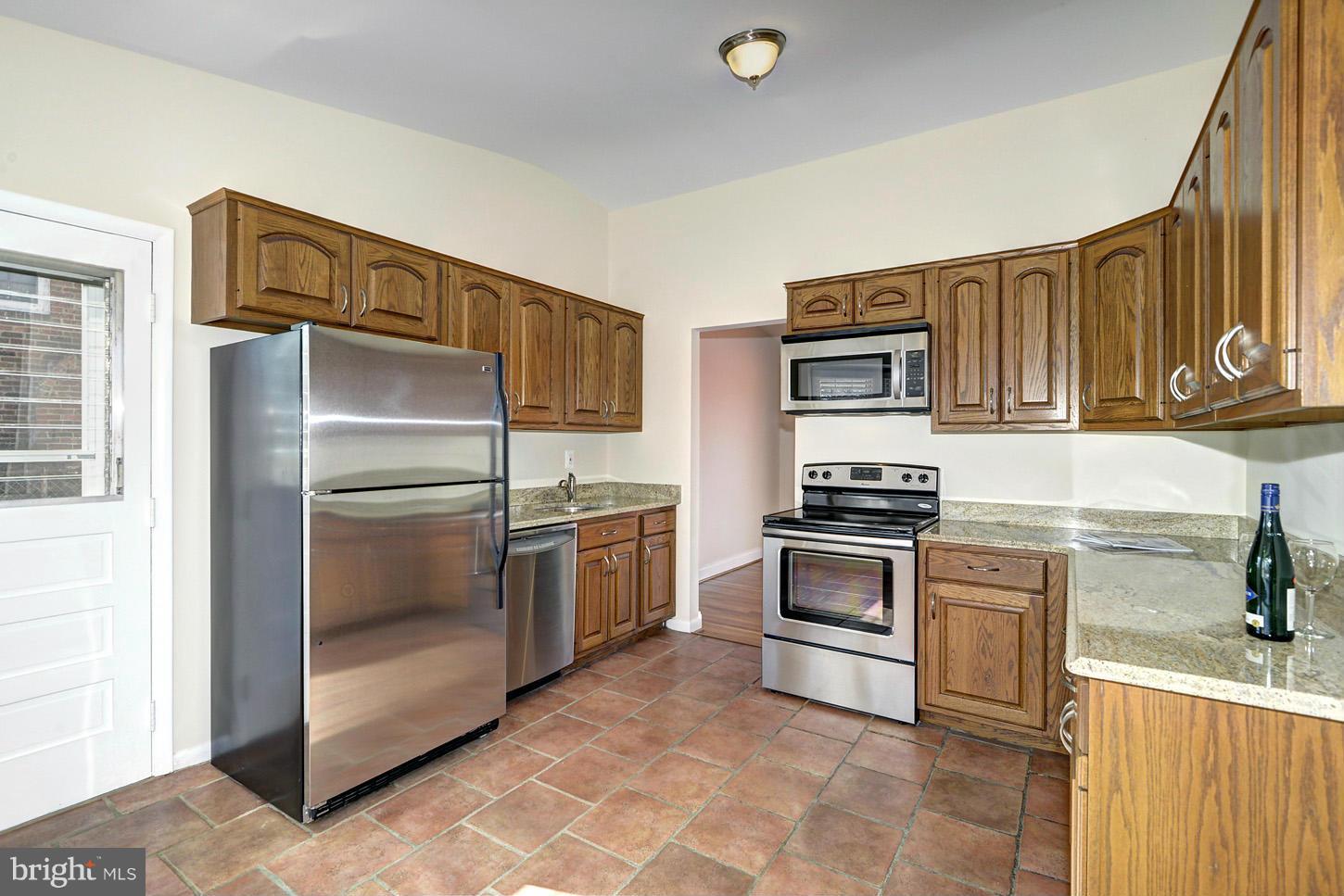 2701 Woodedge Road Silver Spring, MD 20906 - Photo 6 of 27 a kitchen with granite countertop a refrigerator and a stove