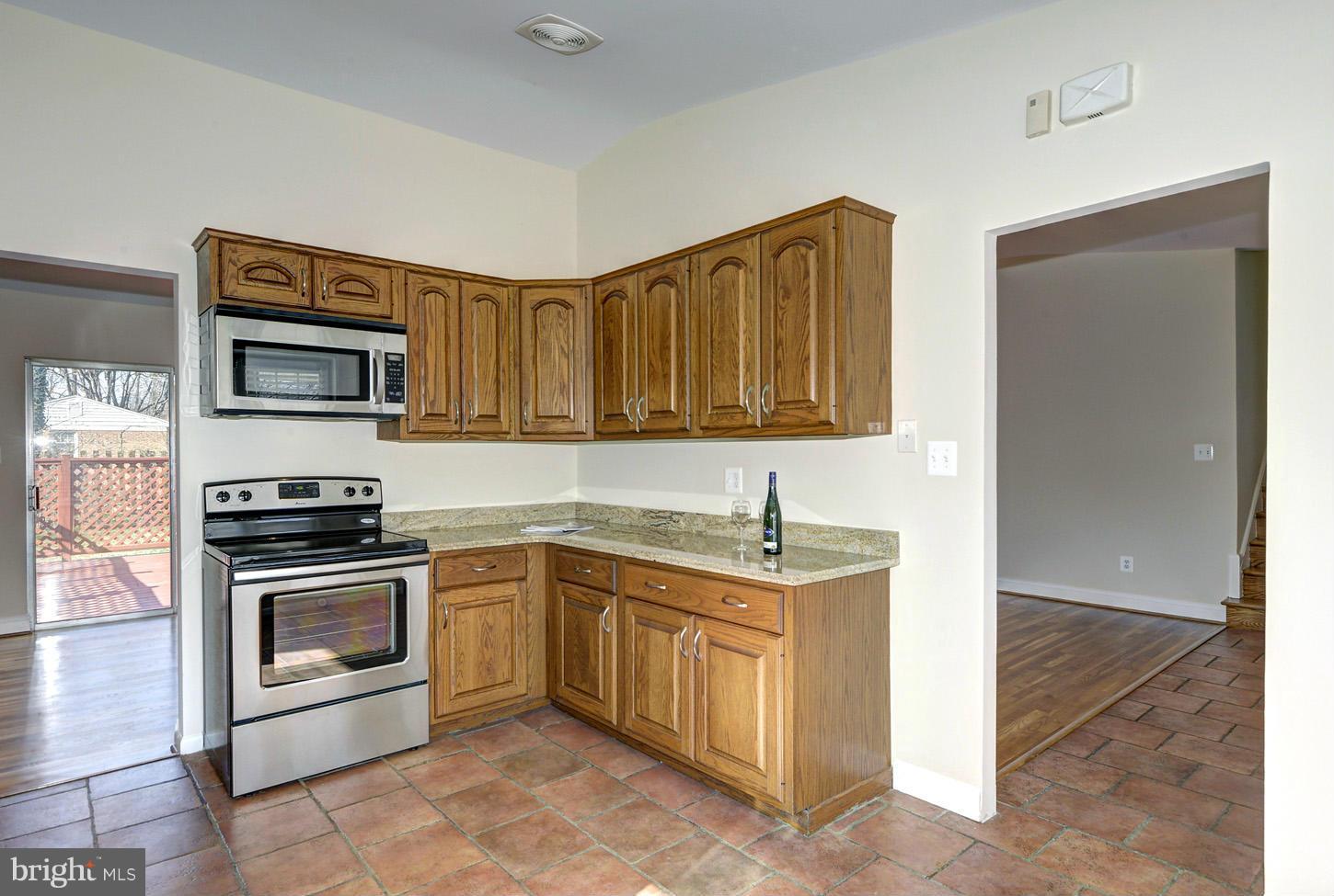 2701 Woodedge Road Silver Spring, MD 20906 - Photo 7 of 27 a kitchen with stainless steel appliances granite countertop a stove and a sink