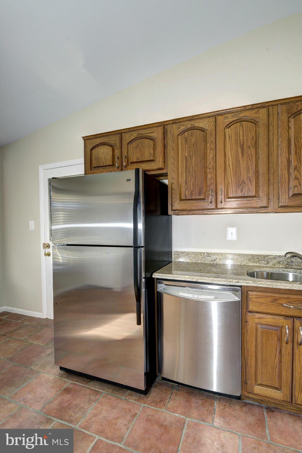 2701 Woodedge Road Silver Spring, MD 20906 - Photo 8 of 27 a kitchen with a stove and a refrigerator