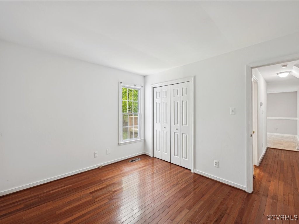 1407 Oldbury Road Midlothian, VA 23113 - Photo 13 of 34 an empty room with wooden floor and windows