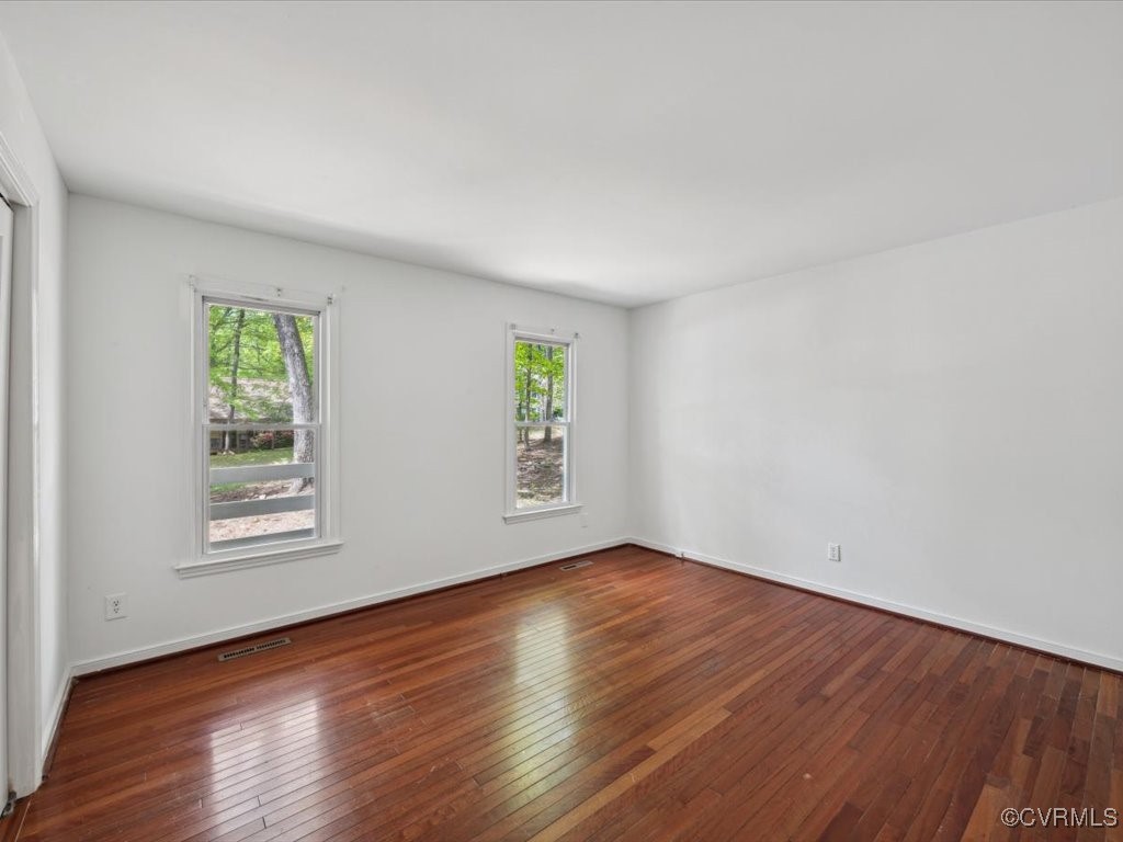 1407 Oldbury Road Midlothian, VA 23113 - Photo 14 of 34 an empty room with wooden floor and windows