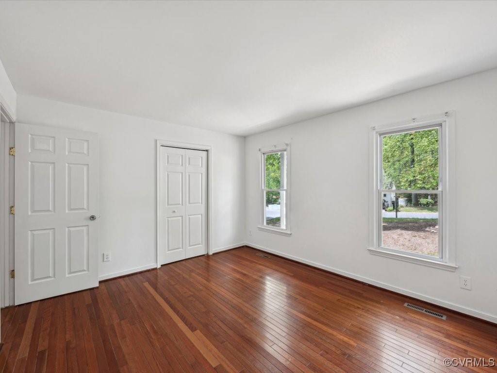 1407 Oldbury Road Midlothian, VA 23113 - Photo 15 of 34 an empty room with wooden floor and windows