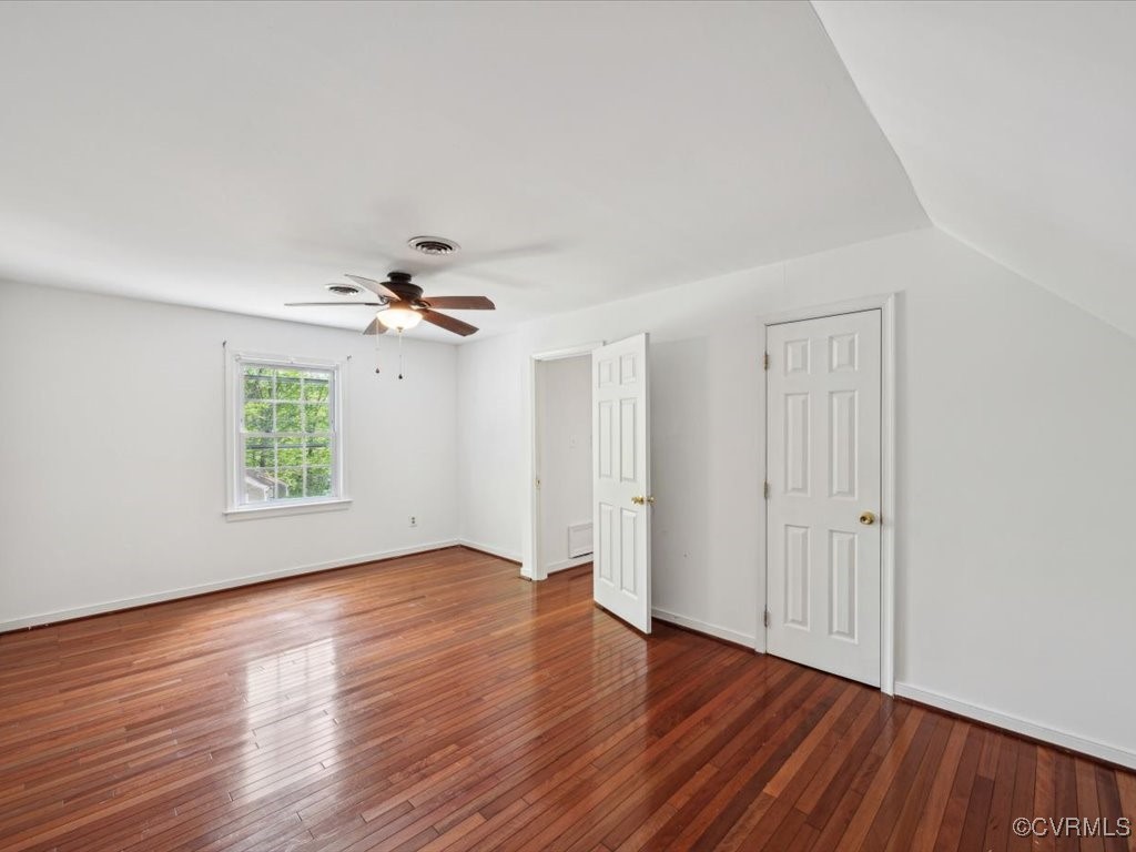 1407 Oldbury Road Midlothian, VA 23113 - Photo 23 of 34 an empty room with wooden floor ceiling fan and windows