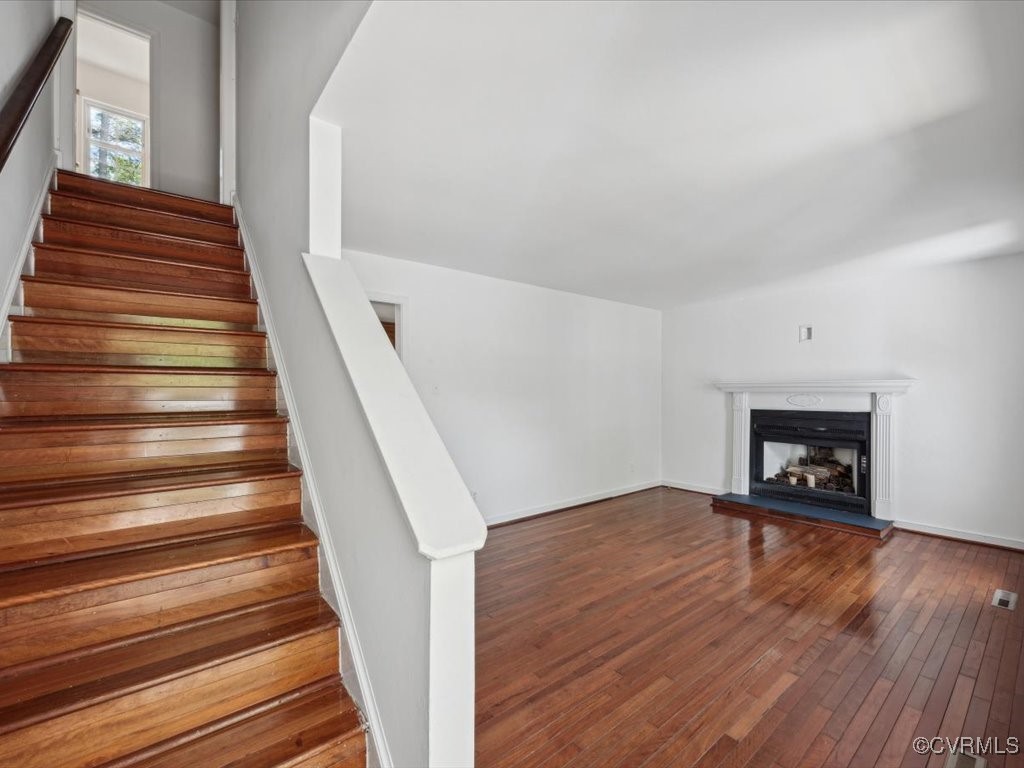 1407 Oldbury Road Midlothian, VA 23113 - Photo 5 of 34 a view of an empty room with wooden floor and a fire place