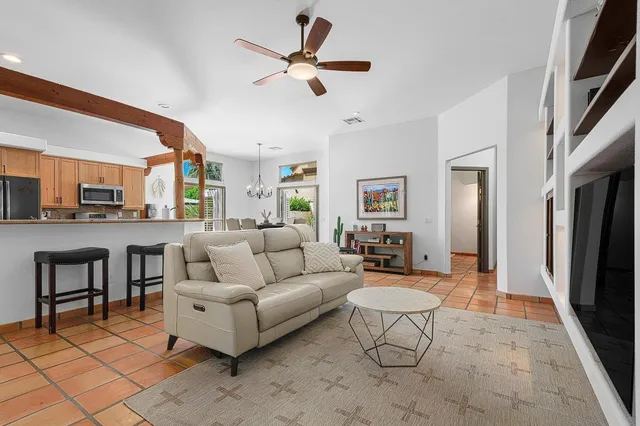 a living room with furniture ceiling fan and a rug