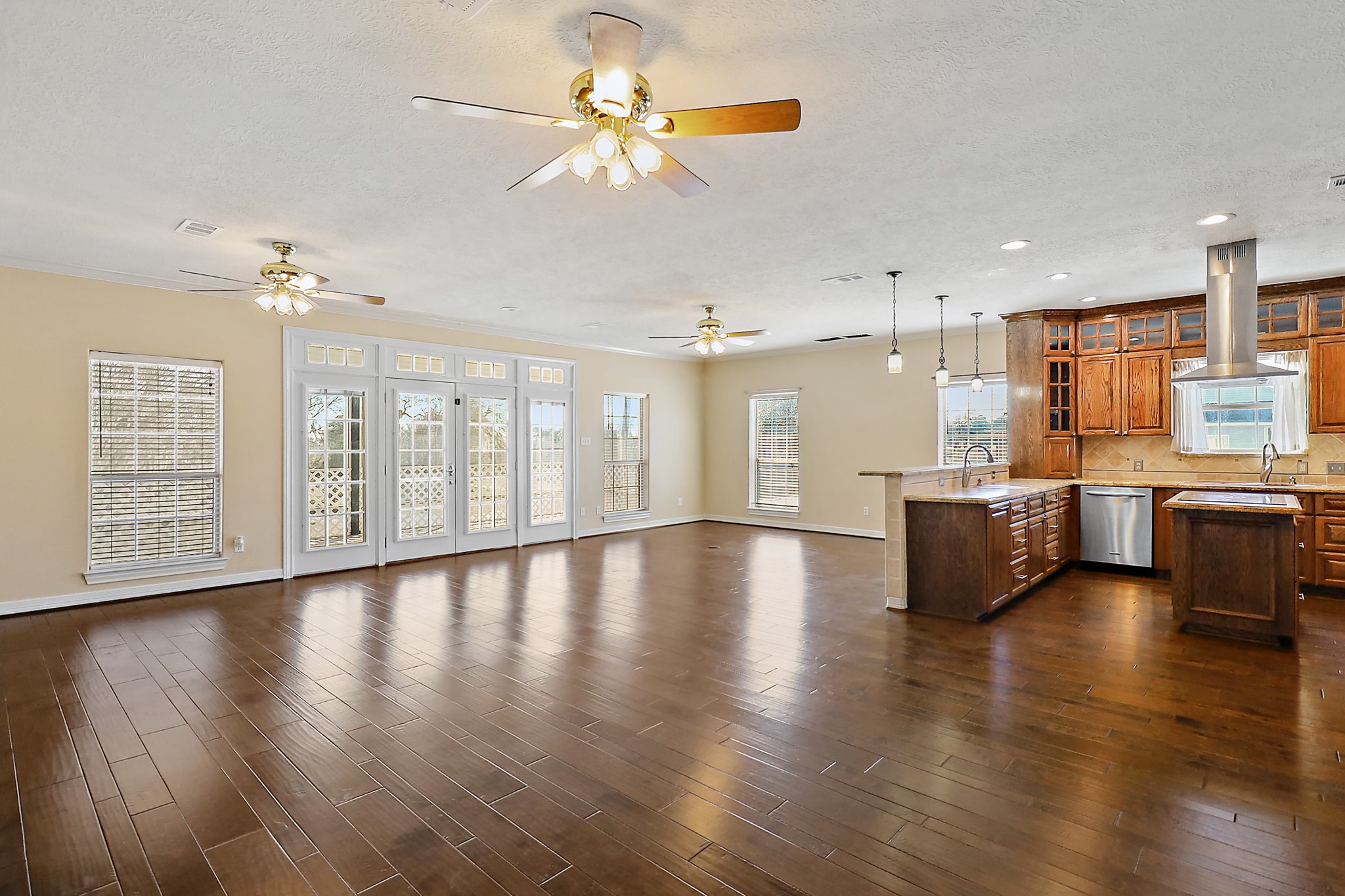 1306 Spring Branch Drive Baytown, TX 77523 - Photo 29 of 38 a view of an empty room with kitchen view and wooden floor