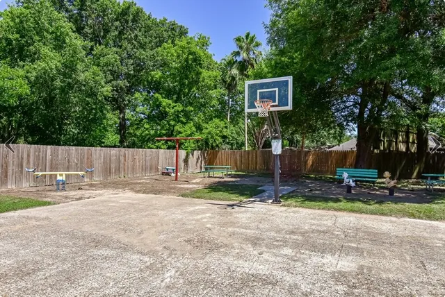 a backyard of a house with fountain and a tree