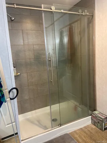 a bathroom with a shower and a sink