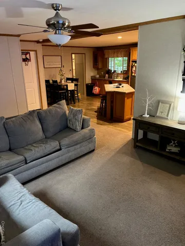 a living room with furniture and a chandelier