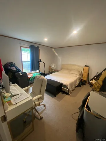 a bedroom with a bed and a chair