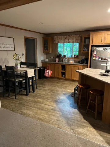 a large white kitchen with lots of counter space a sink and a large window