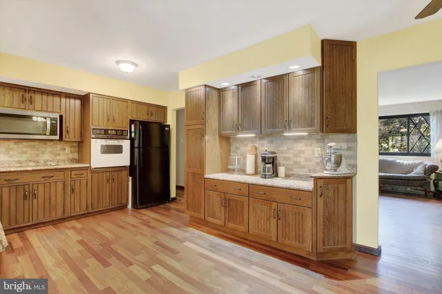 a kitchen with stainless steel appliances a refrigerator and a stove top oven
