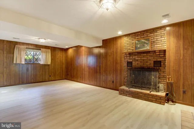 a view of an empty room with a fireplace