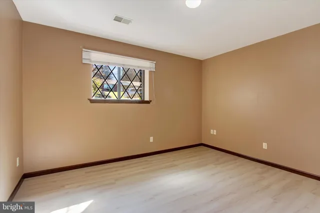 an empty room with a painting on the wall