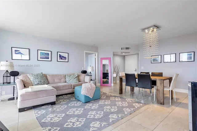 a living room with furniture a rug and a table