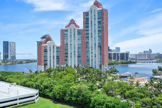 a view of a city with tall buildings and a big yard
