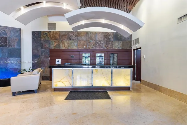 a view of lobby with a floor to ceiling window and fireplace
