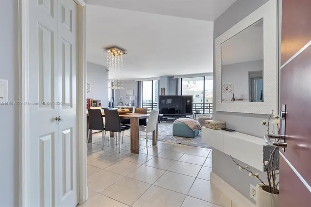 a living room with furniture a rug and a flat screen tv