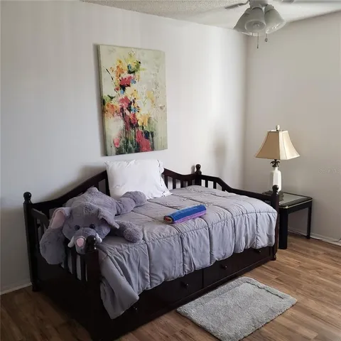 a bedroom with bed and painting on the wall