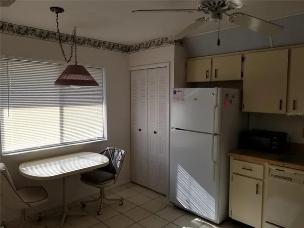 a kitchen with a refrigerator a sink and cabinets