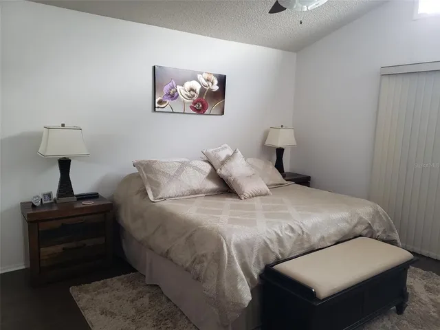 a bedroom with a bed and a lamp on table