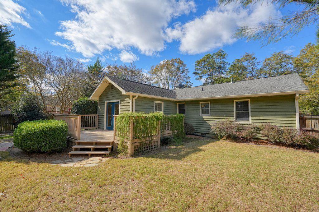 3799 Oglesby Road Powder Springs, GA 30127 - Photo 14 of 39 a front view of a house with a yard and outdoor seating