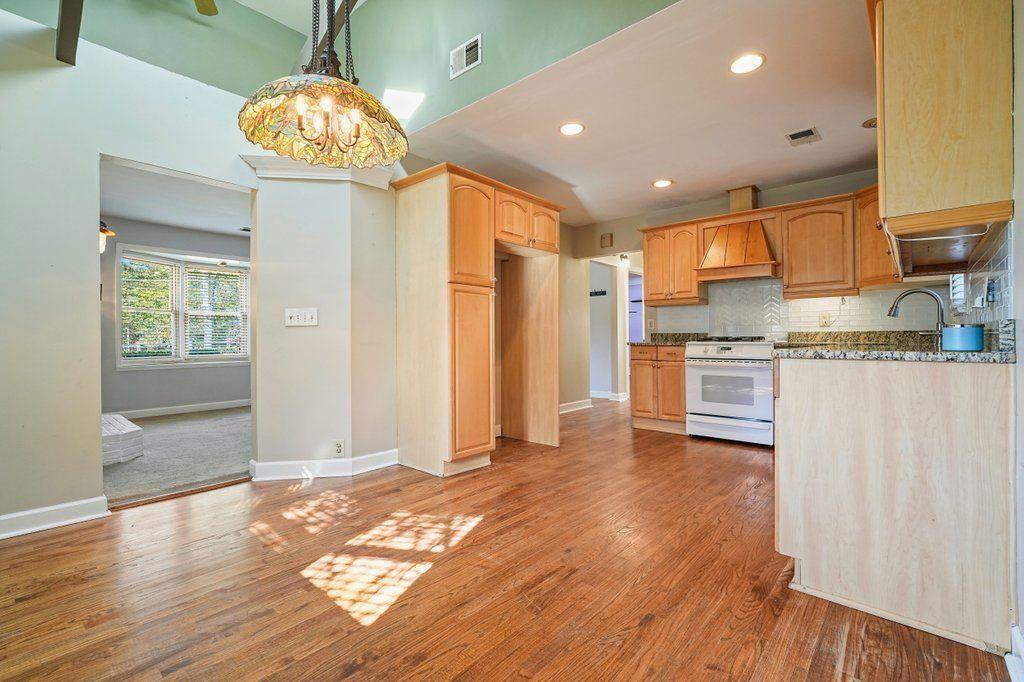 3799 Oglesby Road Powder Springs, GA 30127 - Photo 2 of 39 a open kitchen with stainless steel appliances granite countertop a refrigerator and a stove top oven